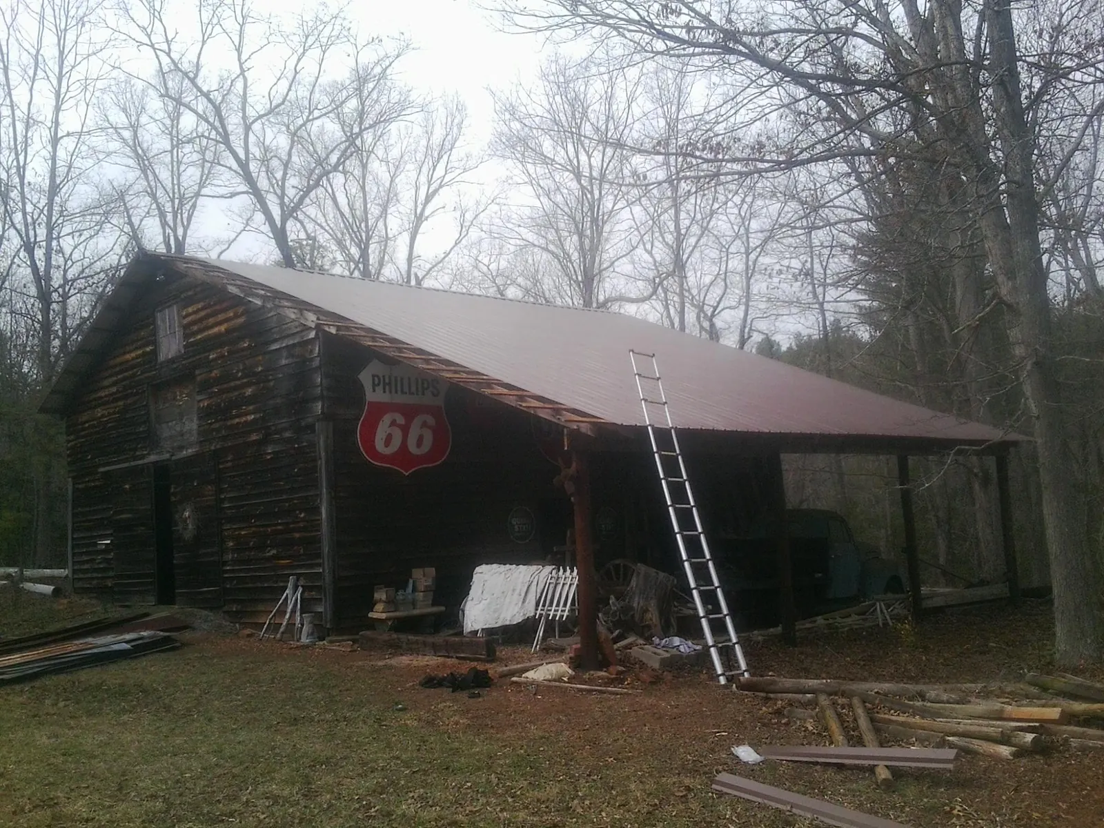 New metal roof on an open sided timber barn with a vintage sign in Maysville